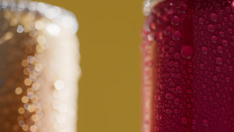 Close-Up-Of-Condensation-Droplets-Running-Down-Takeaway-Cans-Of-Cold-Beer-Or-Soft-Drinks-Against-Yellow-Background